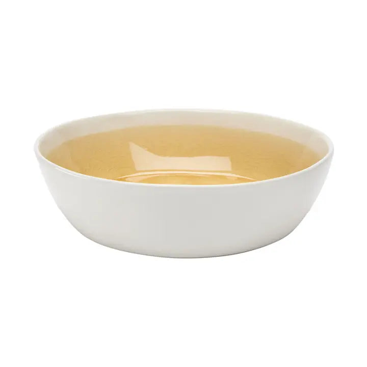 white ceramic cereal bowl with yellow inside on white background