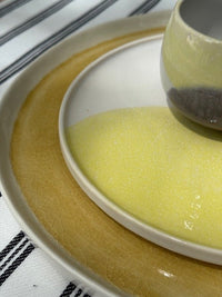 detail of crackles in yellow dinner plate