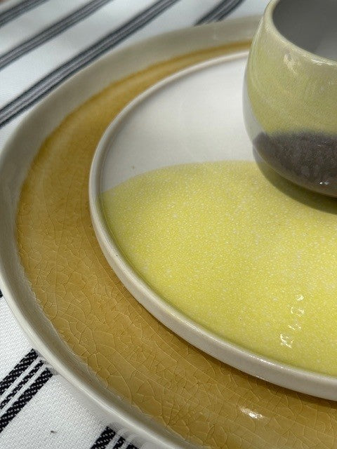 detail of crackles in yellow dinner plate