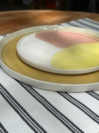 dinner and side plate on striped placemat