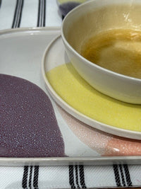 details of ceramic tableware in yellow purple and pink