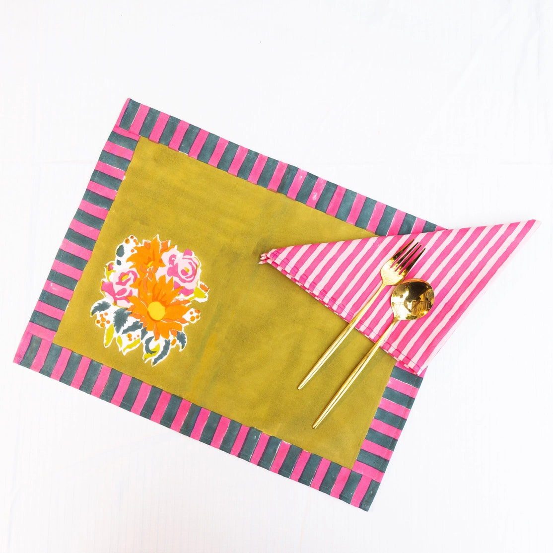 Colorful placemat with floral design and striped edges on a white background