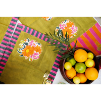 Colorful tablecloth with floral patterns and a bowl of fruits on a white background