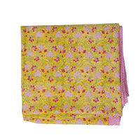 Floral patterned fabric with pink and yellow colors on a white background