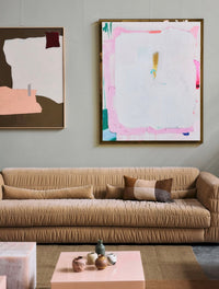 caramel velvet sofa with two abstract paintings an a grey wall