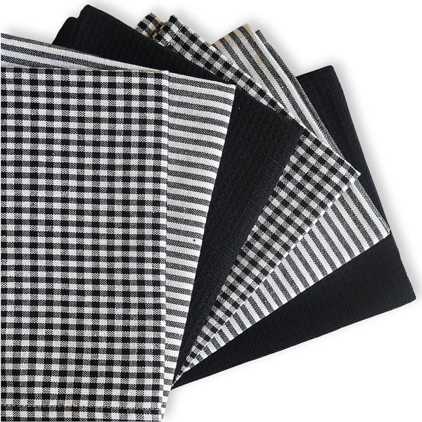 Collection of black and white patterned fabric swatches on a white background