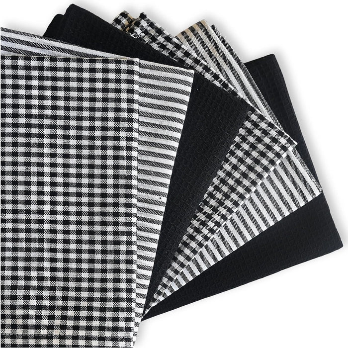 Collection of black and white patterned fabric swatches on a white background