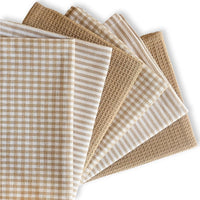 Set of beige and white patterned towels on a white background