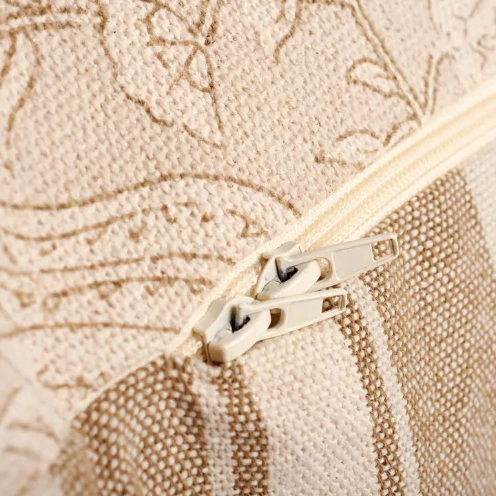 Close-up of a beige zipper on a textured fabric background