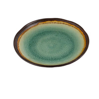 Green ceramic plate with brown rim on a white background