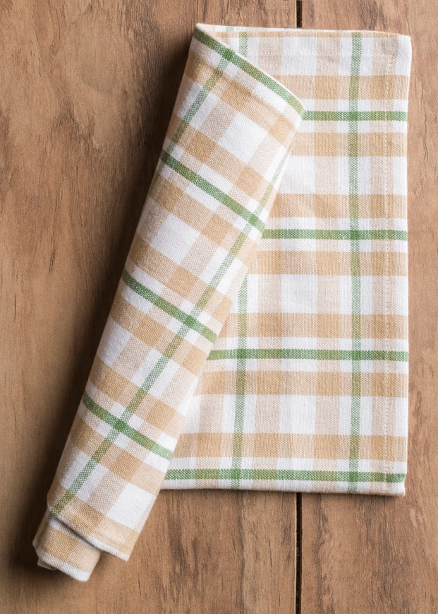 Folded plaid napkin on a wooden surface