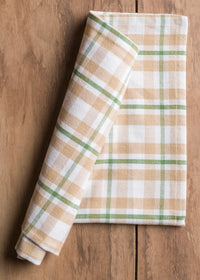 Folded plaid napkin on a wooden surface