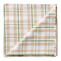 Plaid fabric with green and beige pattern on a white background