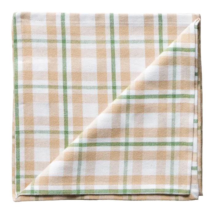 Plaid fabric with green and beige pattern on a white background