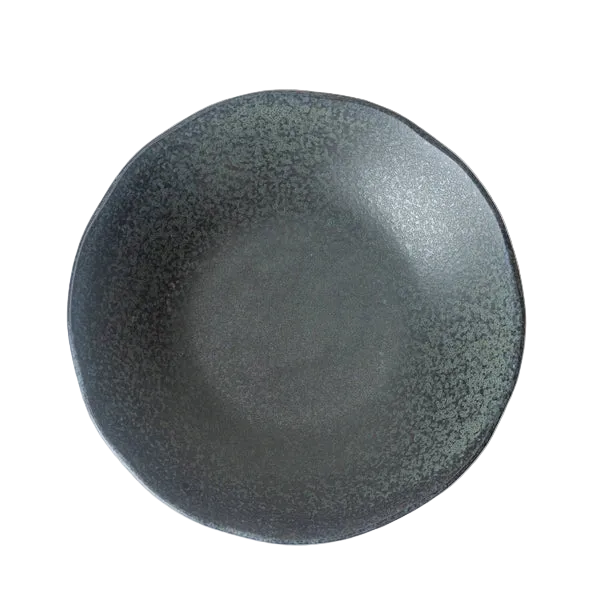 Dark gray ceramic plate on a textured white surface