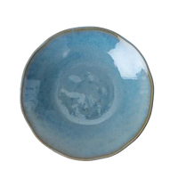 Blue ceramic plate on a white surface