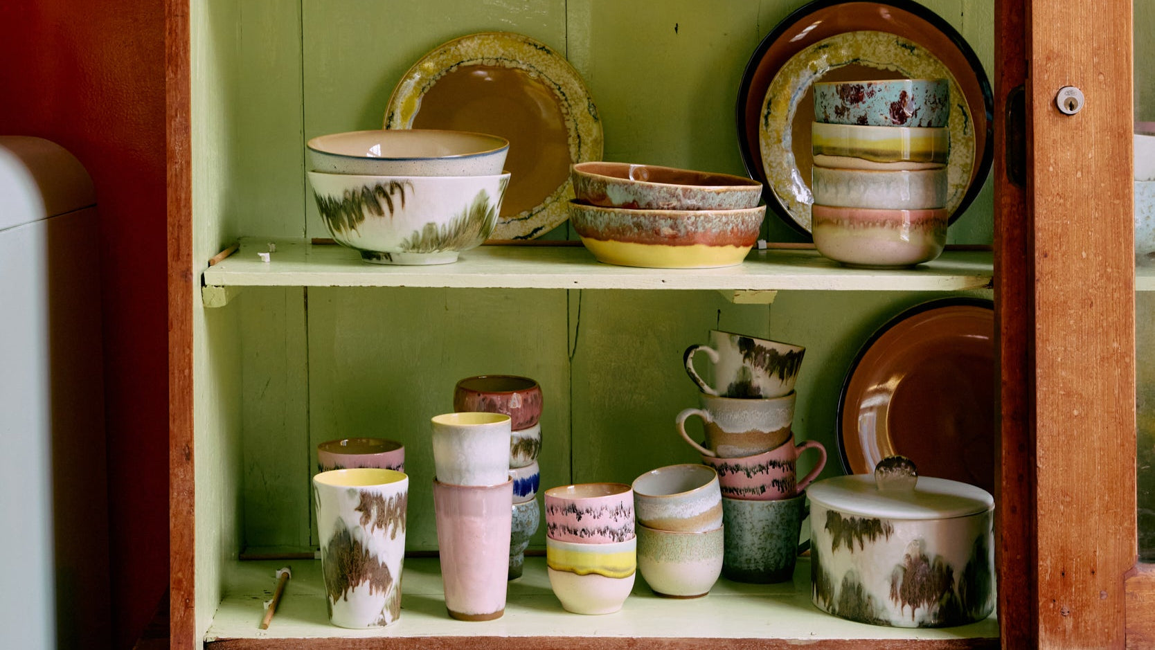 ceramic tableware in vintage cabinet