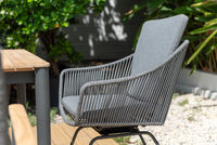 Gray outdoor chair with a wooden table in a garden setting