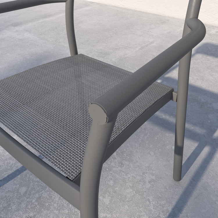 Gray chair with mesh seat on a concrete surface