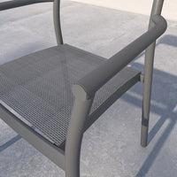 Gray chair with mesh seat on a concrete surface