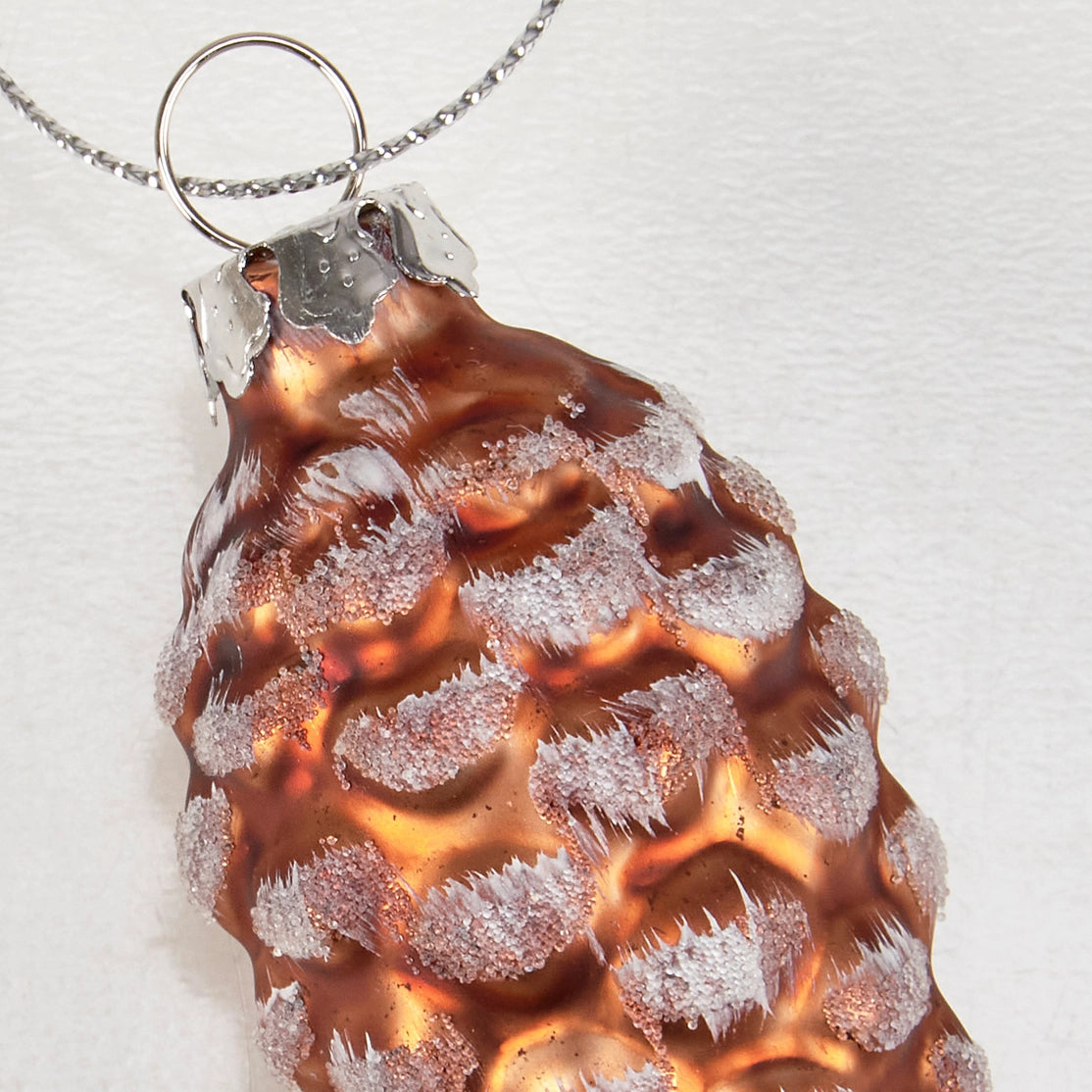 Copper pendant with textured surface on a white background