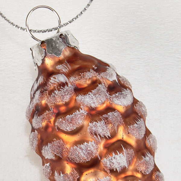 Copper pendant with textured surface on a white background