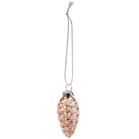 Decorative pinecone ornament with rose gold finish on a white background