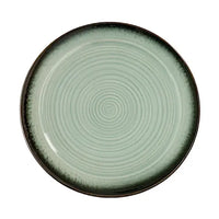Green ceramic plate with concentric circle pattern on a white background