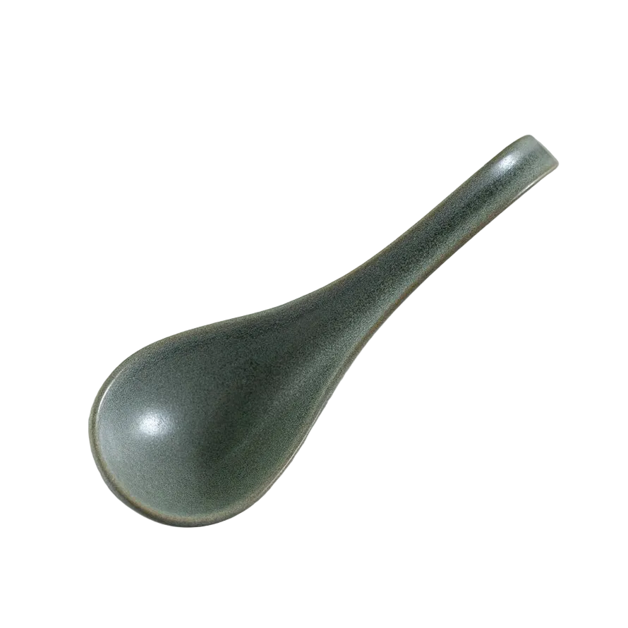 Green ceramic spoon on white background