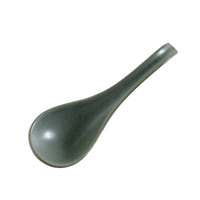 Green ceramic spoon on white background