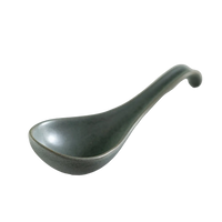 Green ceramic ladle on white background