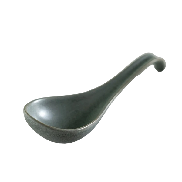 Green ceramic ladle on white background