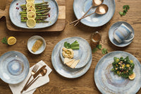 blue ceramic tableware on a wooden table with food