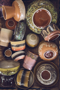 Collection of various ceramic bowls and cups with different textures and colors.