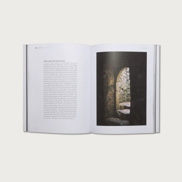 Open book with text on one page and a photograph of a stone archway on the other, on a white background.