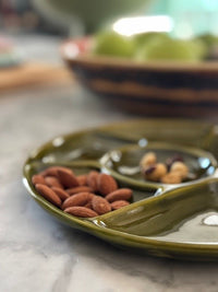green ceramic tray with almons