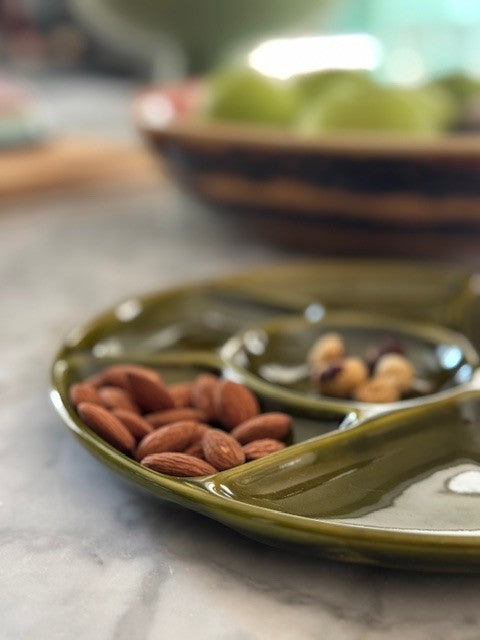 green ceramic tray with almons