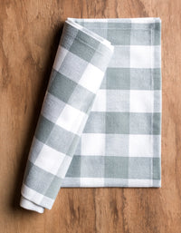 Folded checkered towel on a wooden surface