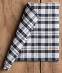 Folded checkered napkin on a wooden surface