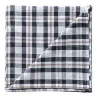 Folded plaid fabric napkin with black, white, and gray pattern on a neutral background
