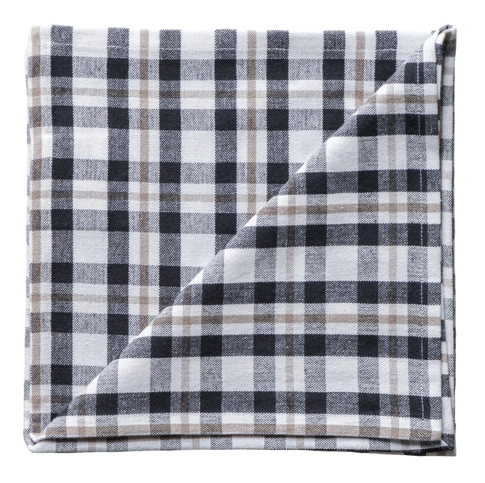 Folded plaid fabric napkin with black, white, and gray pattern on a neutral background