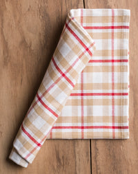 Folded checkered towel on a wooden surface