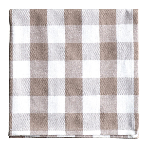 Checkered fabric napkin with brown and white pattern on a gray surface