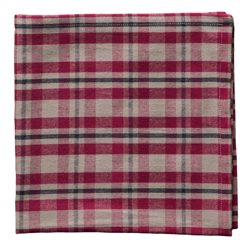 Folded cotton napkin with a red and gray plaid pattern on a white background