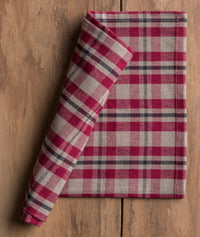 Red and gray plaid  cotton napkin on a wooden surface