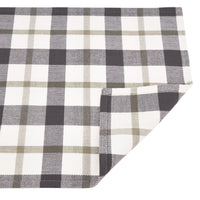 Plaid fabric with black, white, and beige pattern on a white background