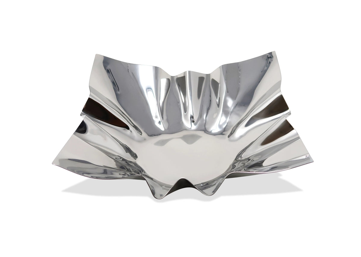 Silver decorative bowl with wavy design on a white background