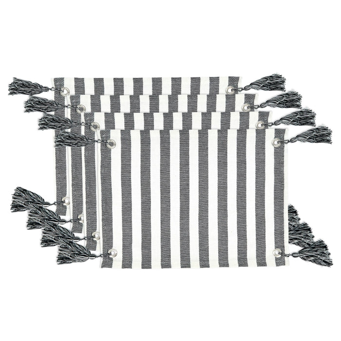 Set of four black and white striped placemats with tassels on a white background