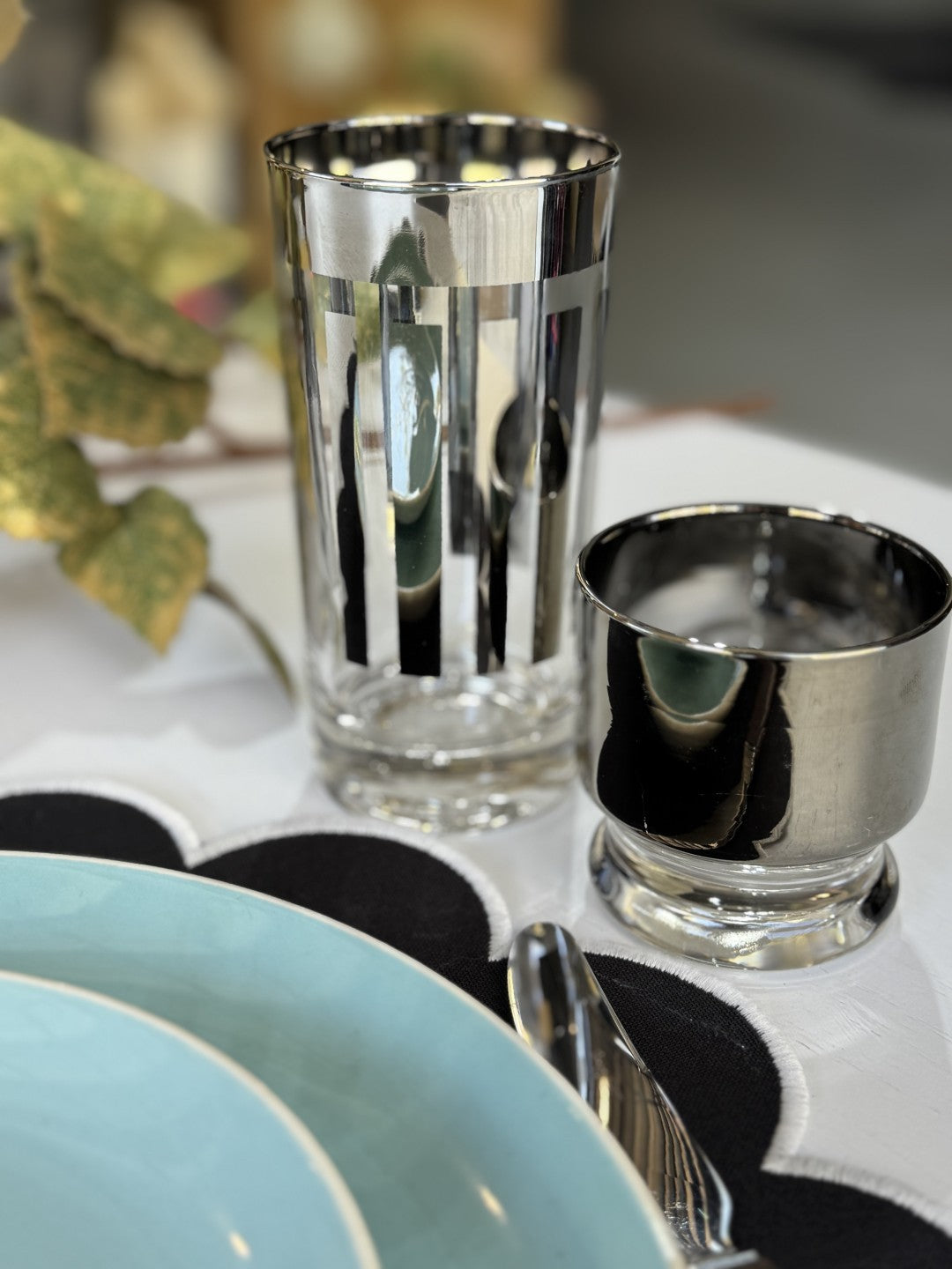 two Mid Century Modern tumblers with silver and dinner and side plate in blue