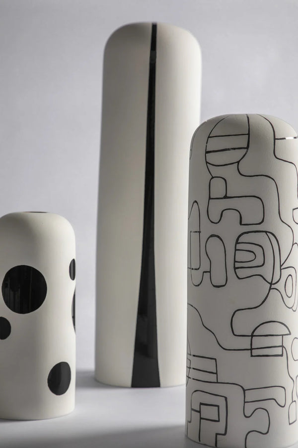 Three ceramic vases with abstract patterns on a white background